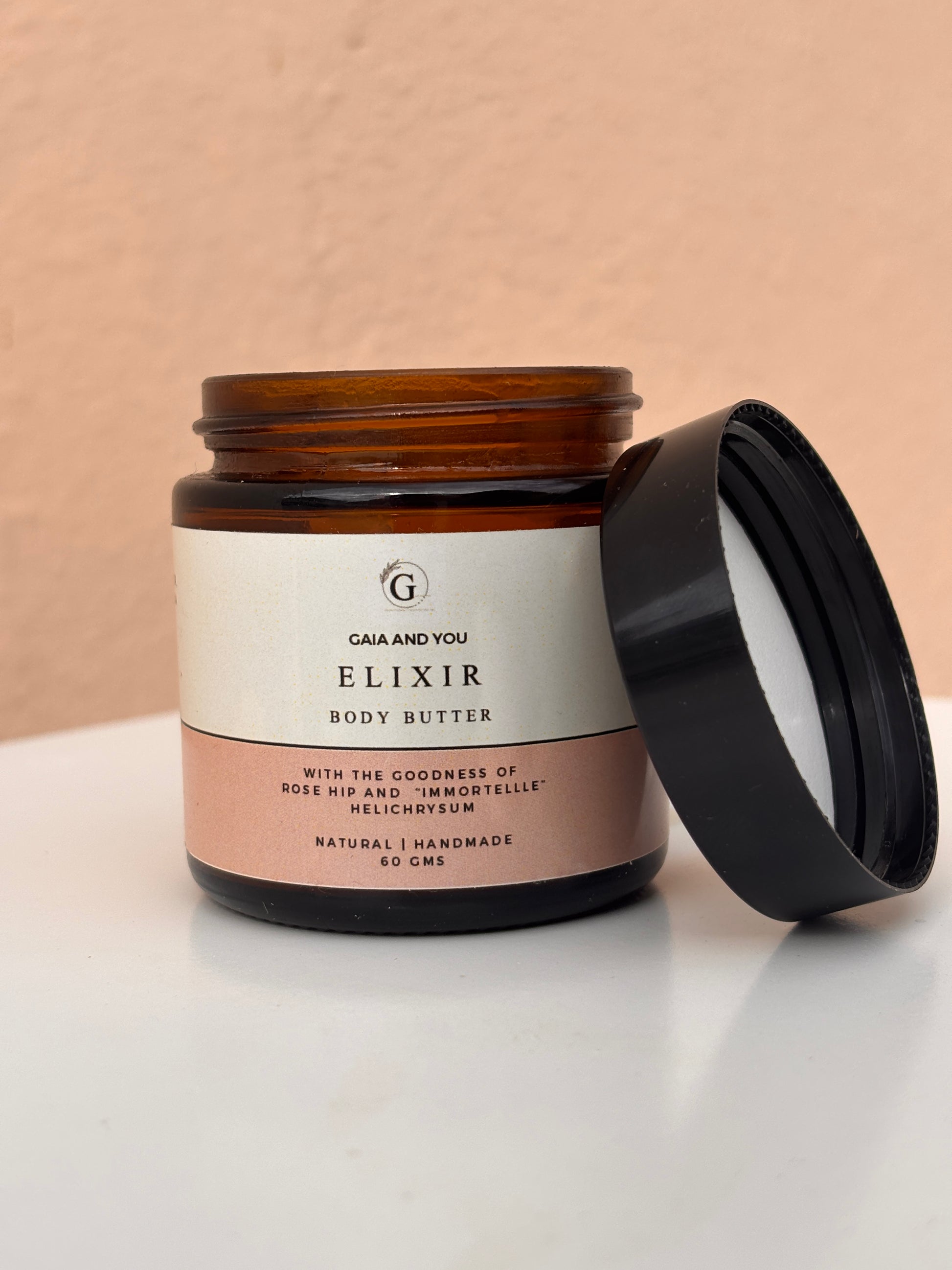 Image of a bottle of Elixir body butter made with rose hip and helichrysum with shea butter, mango butter, and kokum butter.