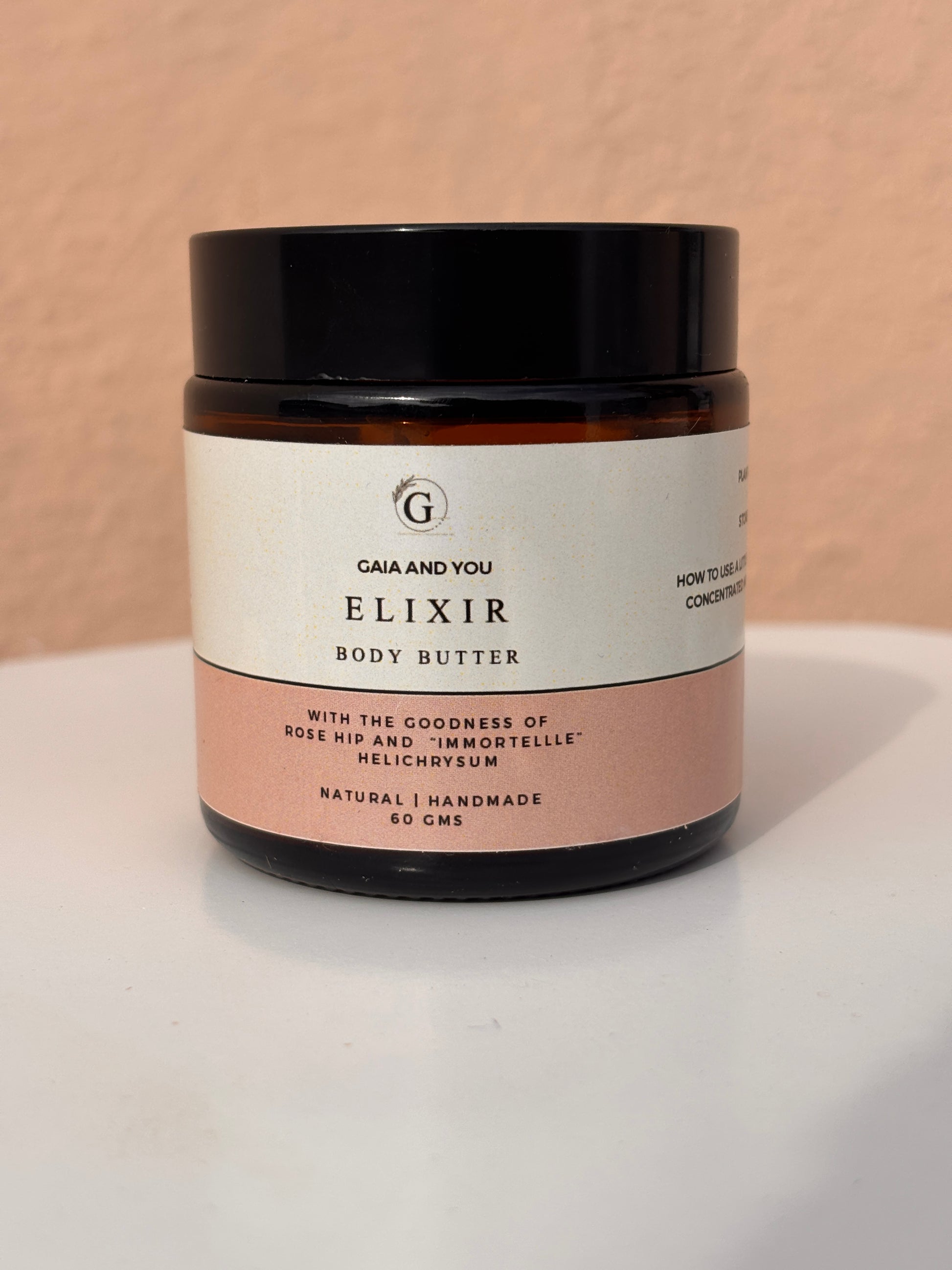 Image of a bottle of Elixir body butter made with rose hip and helichrysum with shea butter, mango butter, and kokum butter.
