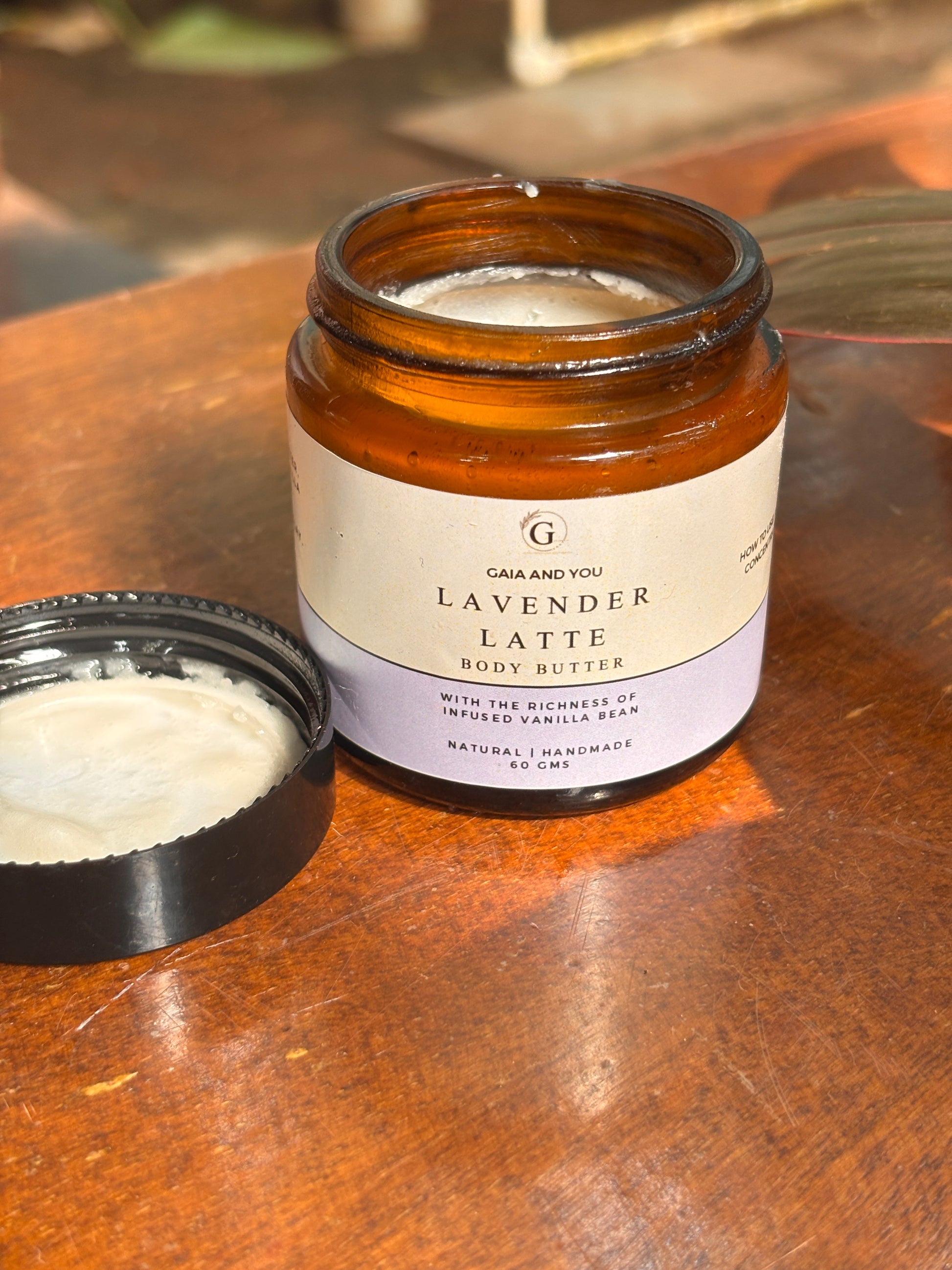 Image of a bottle of body butter made of lavender and vanilla infused jojoba oil, with shea butter, mango butter, and kokum butter.